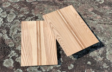 Canoe deck blank with pre-drilled holes and kit parts on a workbench